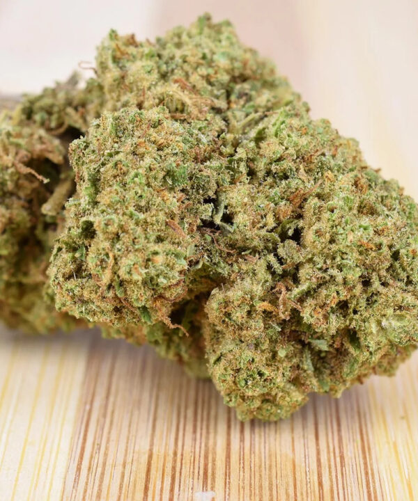 Nærbillede af Vanilla Kush hampeknopper med synlig stilk på trææoverflade