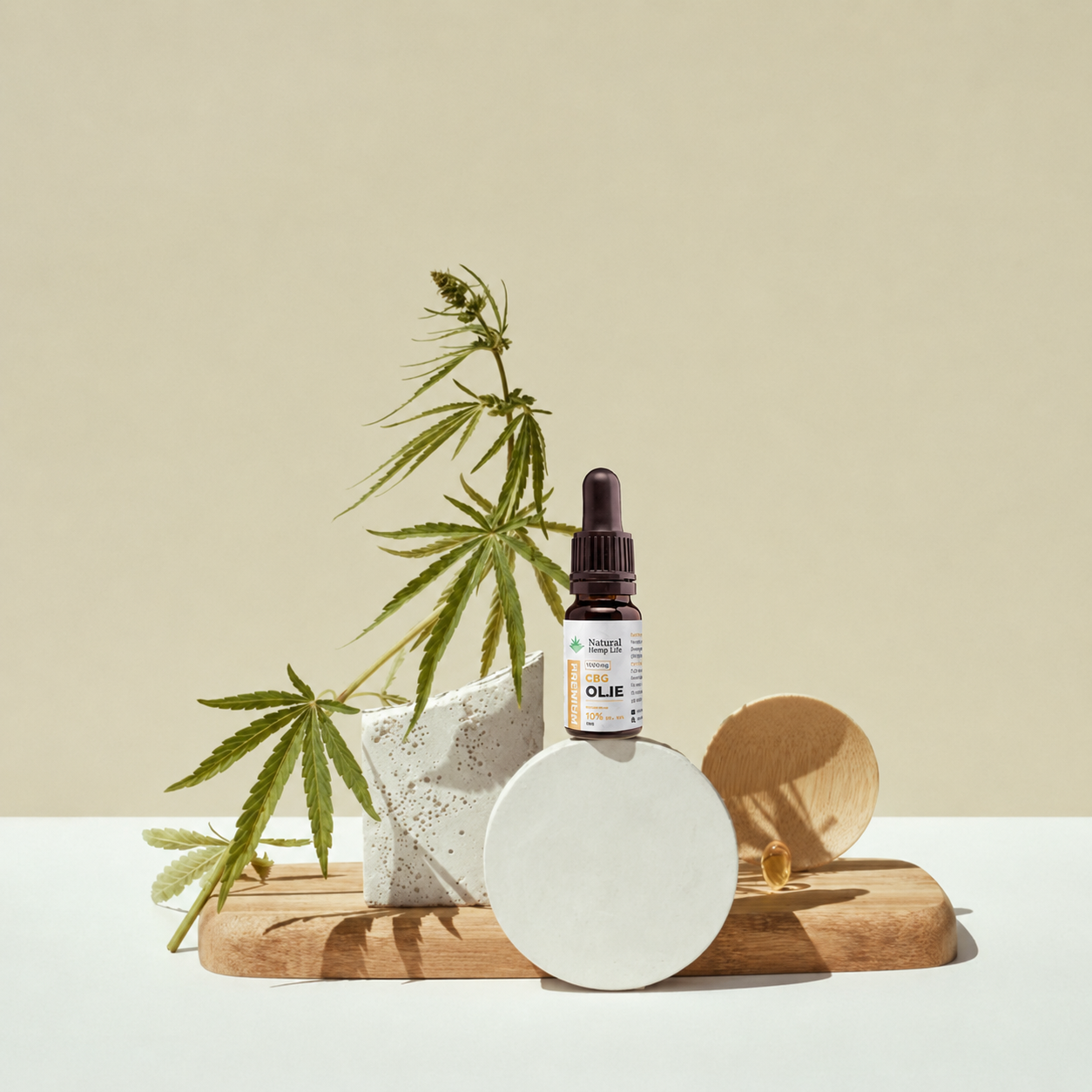 Dråbeflaske med CBG + CBD Olie 10% placeret ved en hampeplante
